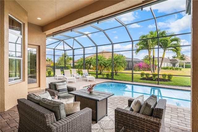 view of pool featuring glass enclosure and a patio area