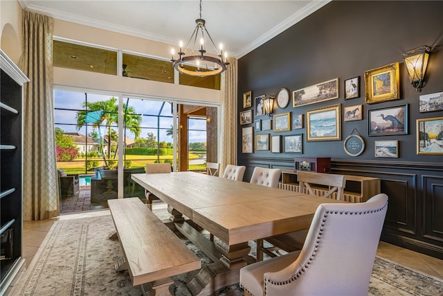 dining area with light tile patterned floors, an inviting chandelier, and crown molding