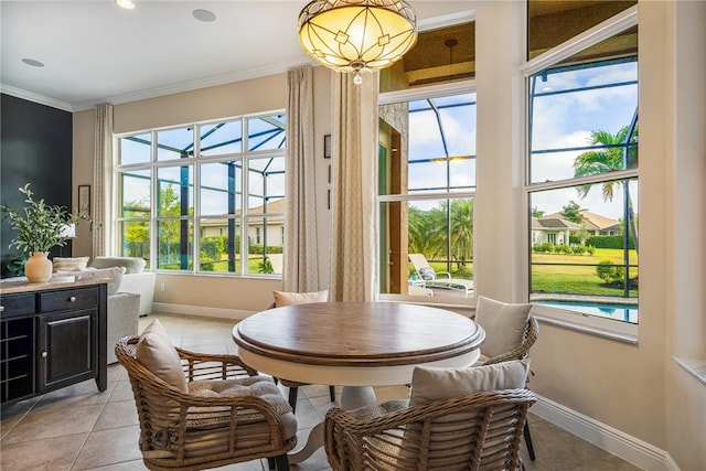 dining area with crown molding and light tile patterned floors