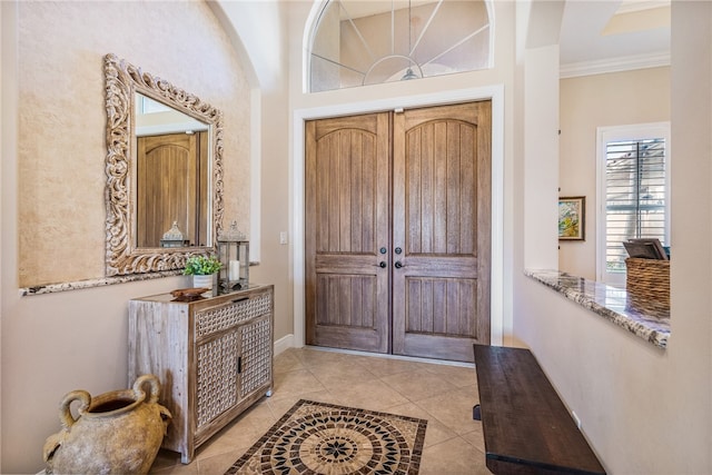 tiled foyer with ornamental molding