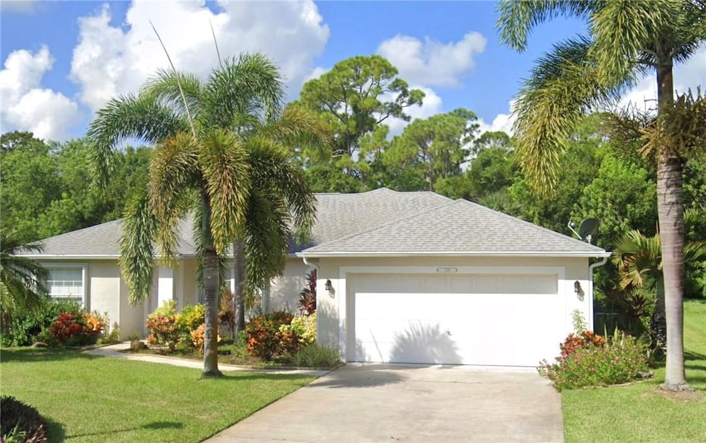 ranch-style home featuring a front yard and a garage