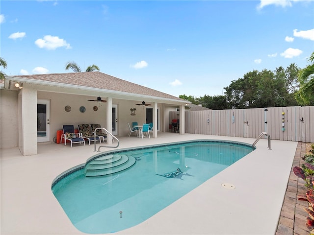 view of swimming pool featuring a gate, fence, a fenced in pool, ceiling fan, and a patio area