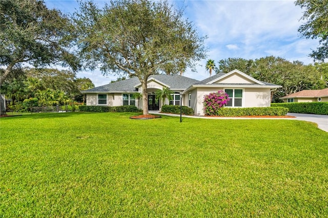 ranch-style home with a front lawn