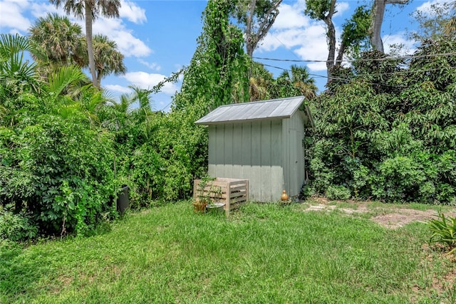 view of outbuilding featuring a lawn