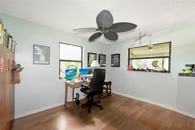 home office with ceiling fan, hardwood / wood-style floors, and a textured ceiling