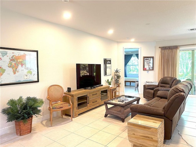 living area featuring recessed lighting, visible vents, baseboards, and light tile patterned floors