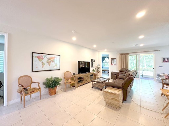 living room with light tile patterned flooring, visible vents, recessed lighting, and baseboards