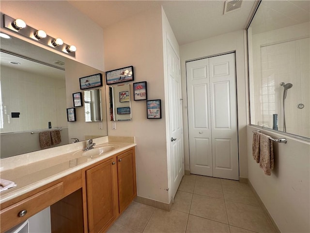 full bath with visible vents, baseboards, walk in shower, tile patterned floors, and vanity