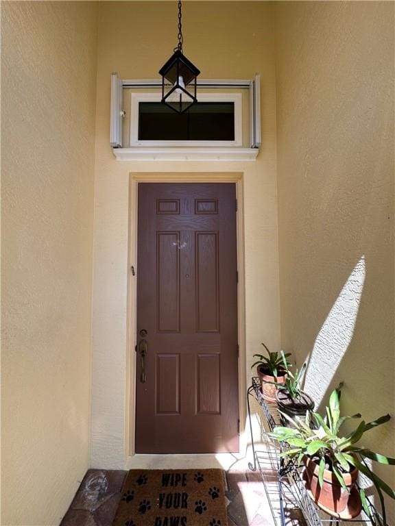 view of exterior entry featuring stucco siding