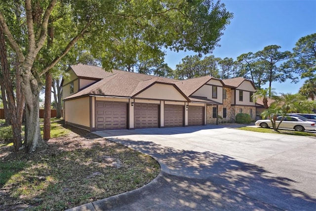 9002 Brighton Ct Unit 2E, Melbourne, FL 32904 - view of front of house featuring stone siding, concrete driveway, a garage, and roof with shingles