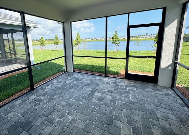 unfurnished sunroom with a water view