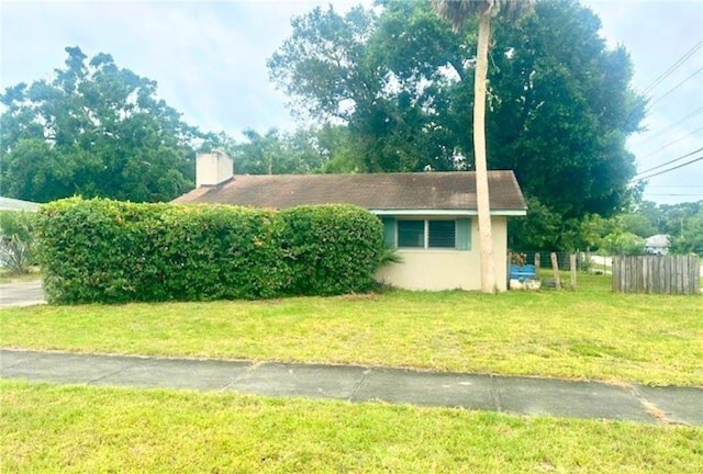 1606 34th Ave, Vero Beach, FL 32960 - view of home's exterior with a chimney and stucco siding