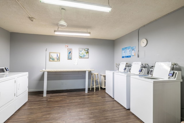 laundry area with independent washer and dryer, a textured ceiling, and dark wood-type flooring