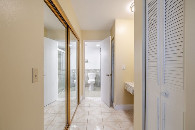 hall with light tile patterned floors