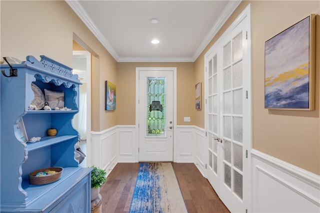 5417 Antigua Cir, Vero Beach, FL 32967 - foyer entrance featuring dark wood-type flooring, wainscoting, ornamental molding, a decorative wall, and french doors
