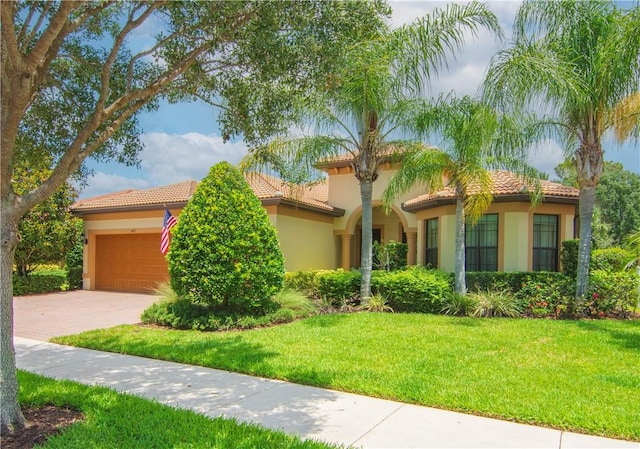 5417 Antigua Cir, Vero Beach, FL 32967 - mediterranean / spanish house with a tiled roof, a garage, stucco siding, a front lawn, and driveway