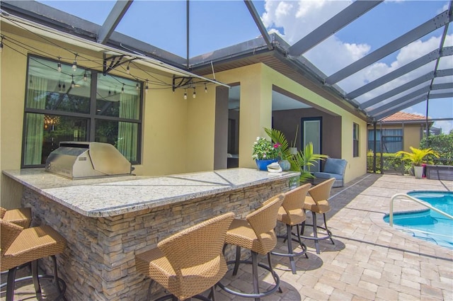 5417 Antigua Cir, Vero Beach, FL 32967 - view of patio featuring glass enclosure, an outdoor kitchen, and an outdoor pool