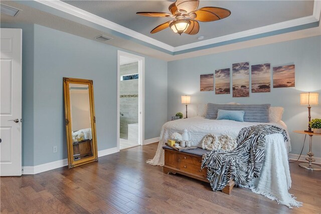 5417 Antigua Cir, Vero Beach, FL 32967 - bedroom with a tray ceiling, wood finished floors, baseboards, ornamental molding, and ensuite bath