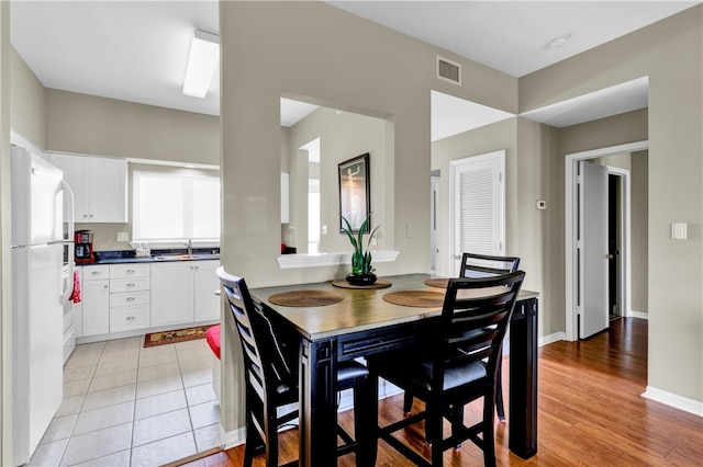 dining space featuring light hardwood / wood-style floors and sink