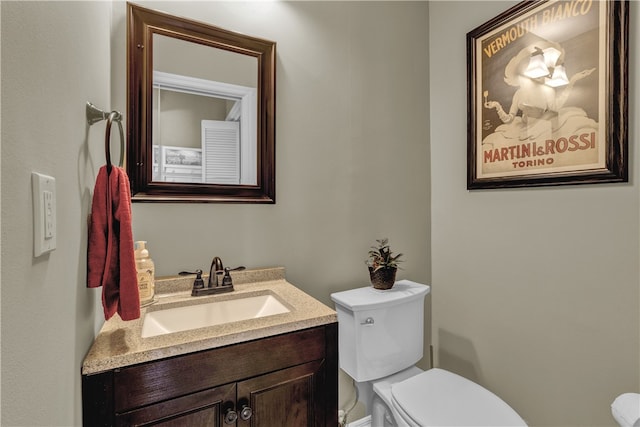 bathroom featuring toilet and vanity