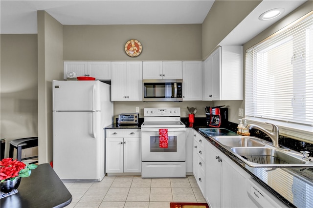 kitchen with white cabinetry, light tile patterned floors, white appliances, and sink