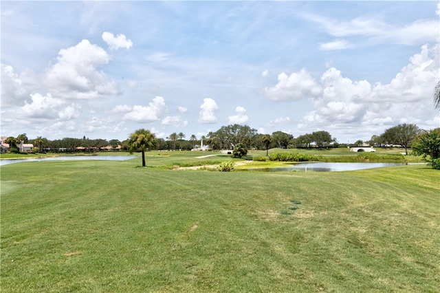 view of community featuring a water view and a lawn