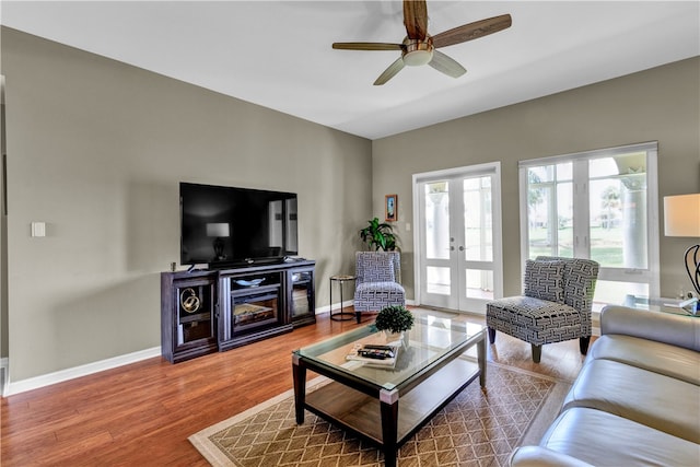 living room with hardwood / wood-style floors, ceiling fan, and french doors