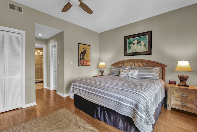 bedroom with ceiling fan, connected bathroom, and light hardwood / wood-style flooring