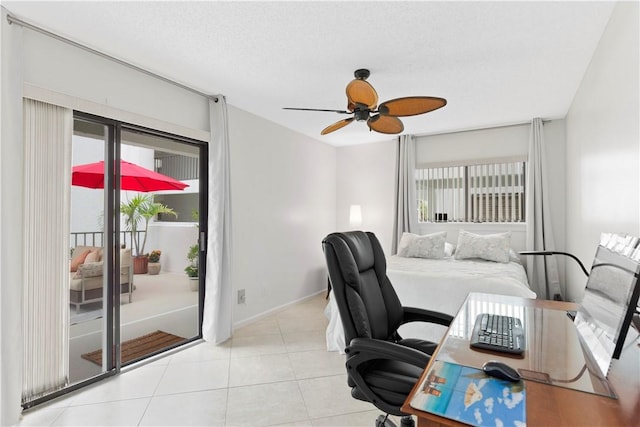 bedroom featuring ceiling fan, light tile patterned flooring, a textured ceiling, and access to outside