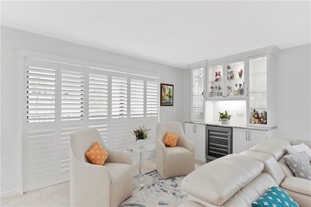 living room with light tile patterned floors, beverage cooler, and indoor bar