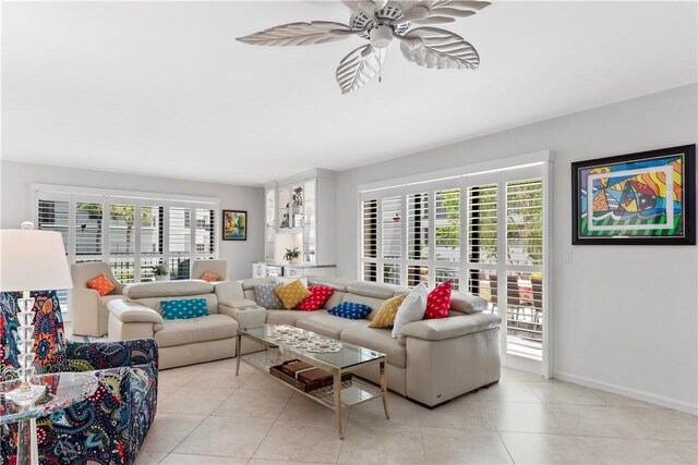 tiled living room with ceiling fan and a healthy amount of sunlight