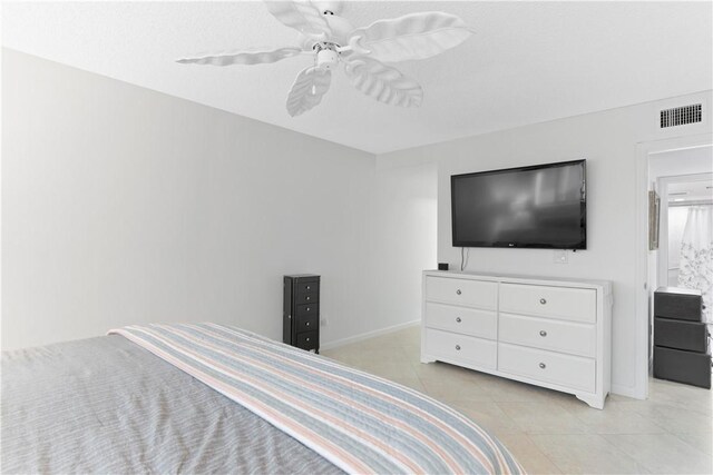 bedroom featuring ceiling fan and light tile patterned floors