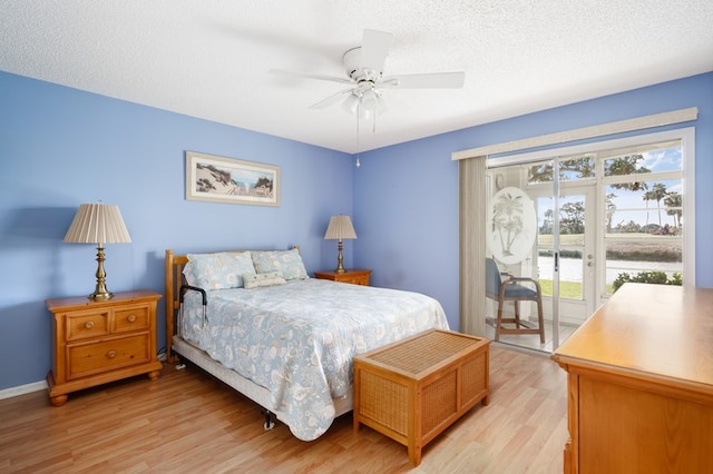 bedroom with ceiling fan, a textured ceiling, light wood-type flooring, and access to outside