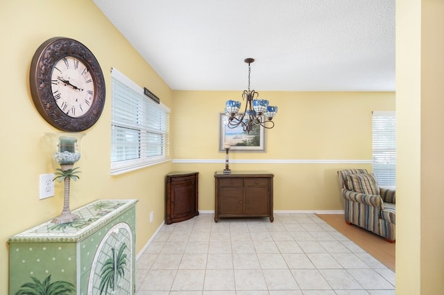 tiled dining room with a chandelier