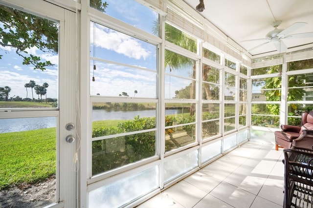 sunroom with a water view and ceiling fan