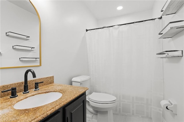 bathroom with toilet and vanity