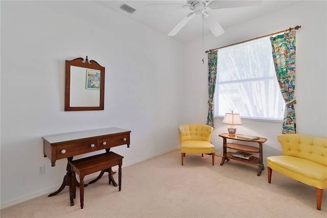 living area featuring ceiling fan and light carpet