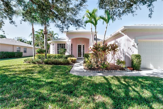 view of front of property with a front lawn and a garage