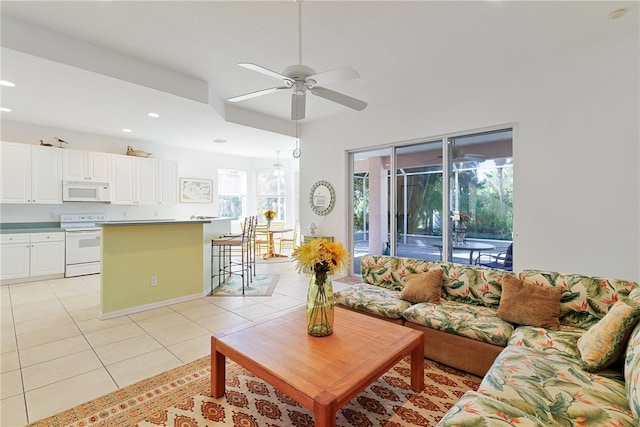 tiled living room with plenty of natural light and ceiling fan