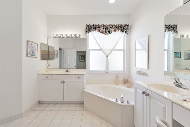 bathroom with tile patterned flooring, a bath, and vanity