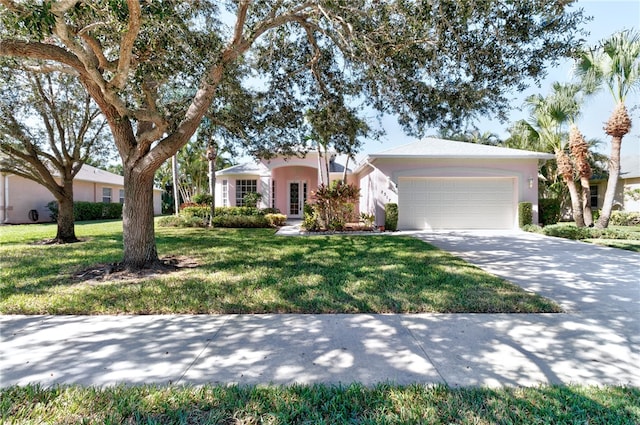 ranch-style house with a garage and a front lawn