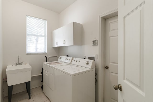 laundry room featuring cabinets, independent washer and dryer, and light tile patterned flooring