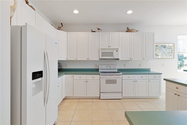 kitchen featuring white cabinetry, light tile patterned floors, and white appliances