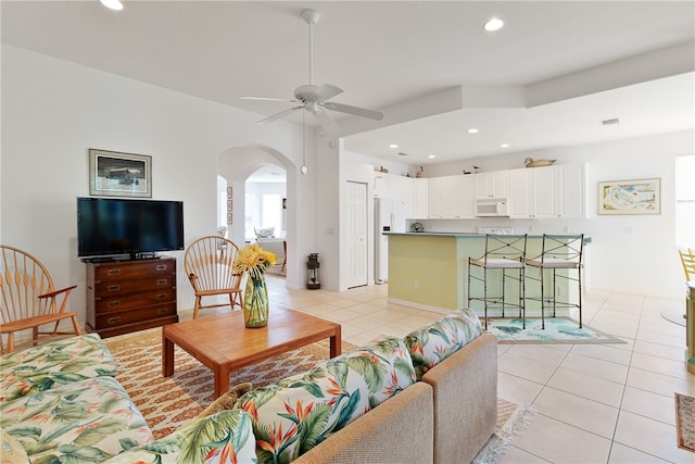 tiled living room featuring ceiling fan