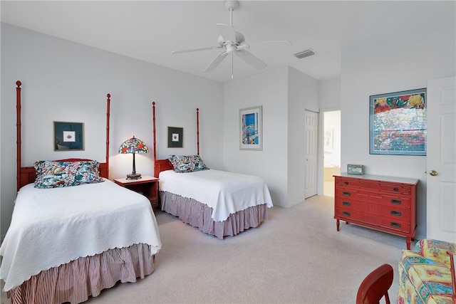 carpeted bedroom with ceiling fan, a closet, and ensuite bathroom