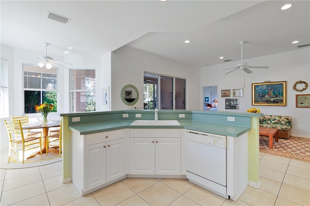 kitchen with ceiling fan, dishwasher, sink, light tile patterned floors, and white cabinets