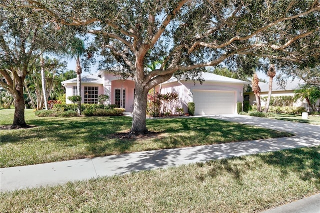 single story home featuring a garage and a front lawn