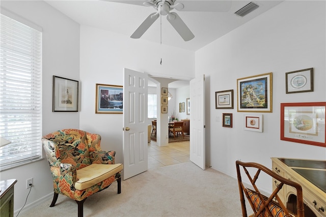 sitting room with light colored carpet and ceiling fan