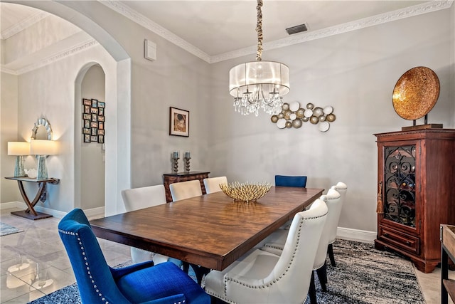 dining room with ornamental molding and light tile patterned flooring