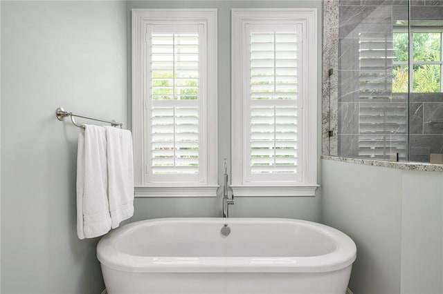 40 White Orchid Way, Vero Beach, FL 32963 - bathroom featuring a freestanding tub and a tile shower